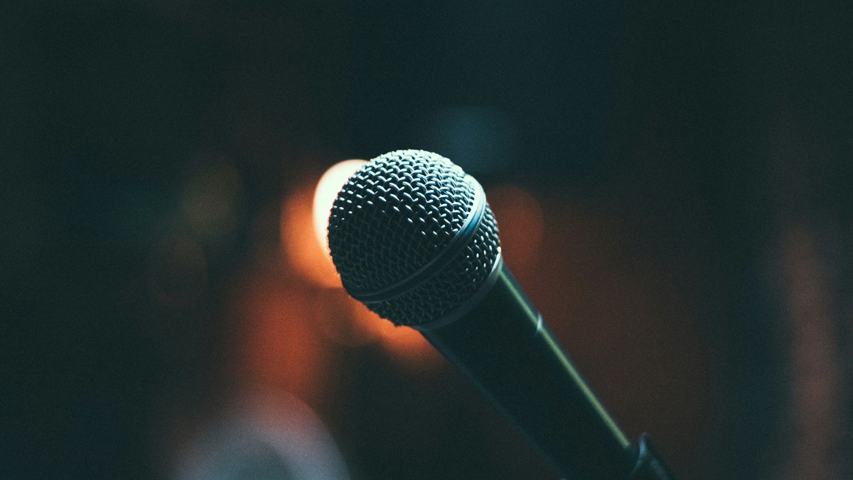 Close-up of a microphone on a dark stage