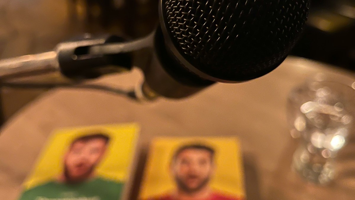 Microphone beside comedy show flyers on a table