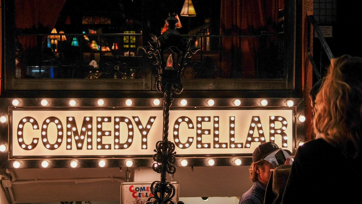 Comedy Cellar entrance sign lit up at night