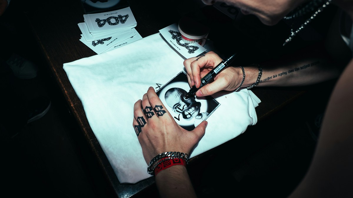 Artist signing an autograph for a fan