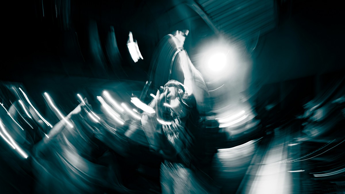 Performer in motion under stage lights