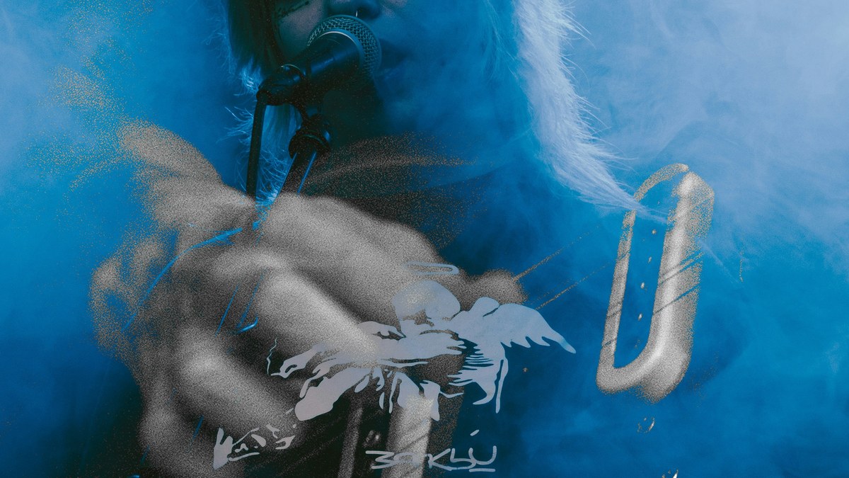 Singer performing in blue stage smoke