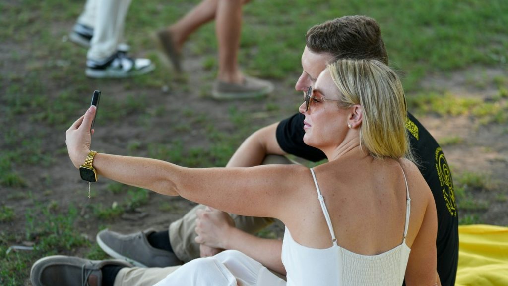 Couple taking a selfie together outdoors at an event