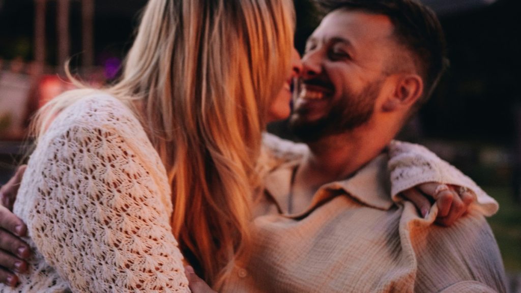 Happy couple embracing outdoors at night