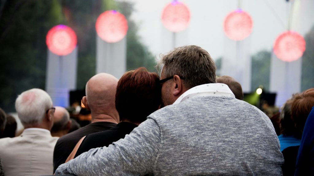 Couple watching an outdoor daytime concert together